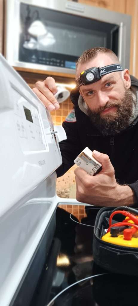 Dan of 877MRFIX06 working on an oven/range in Iowa.