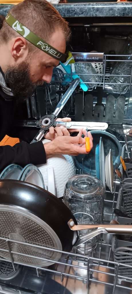 Dan of 877mrfix06 cleaning the nozzles on a dish dishwasher sprayer.