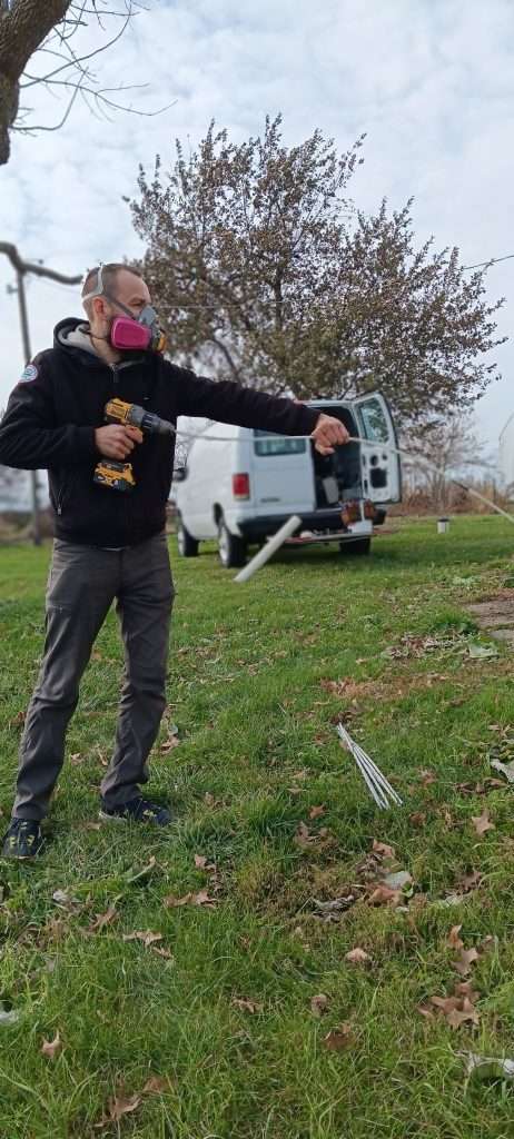 Dan outside a home cleaning a dryer vent.