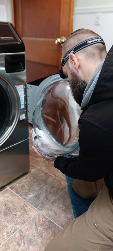 Dan Cleans The Door And Seal On A Washer.