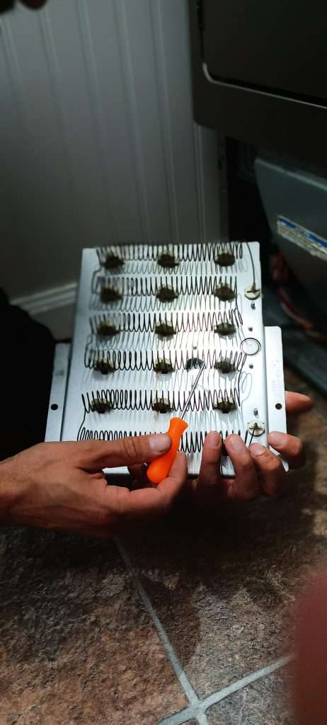 Dan Inspects The Heat Element On Dryer.