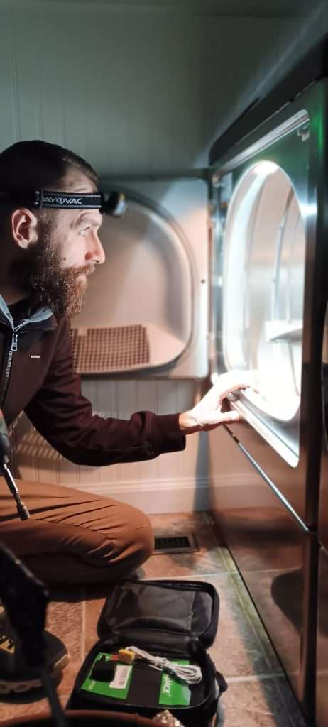 Dan Inspects The Interior Of A Dryer.